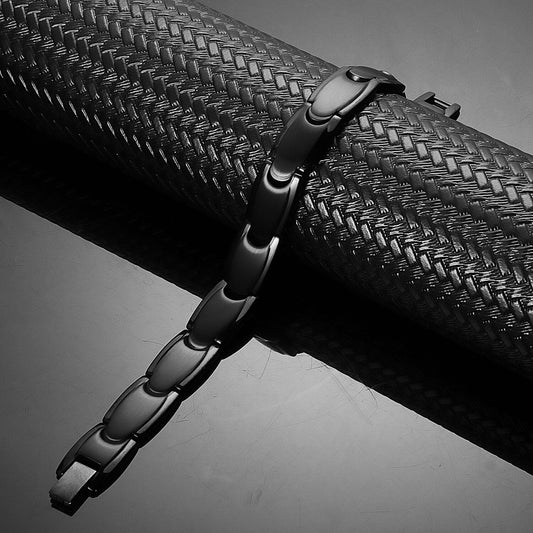 Close-up of a woman's hand wearing a stainless steel magnetic bracelet in black color, model B042MB