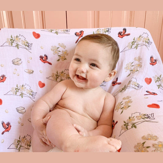 Floral-themed baby muslin swaddle blanket and burp cloth set, featuring delicate pink and green flower patterns.