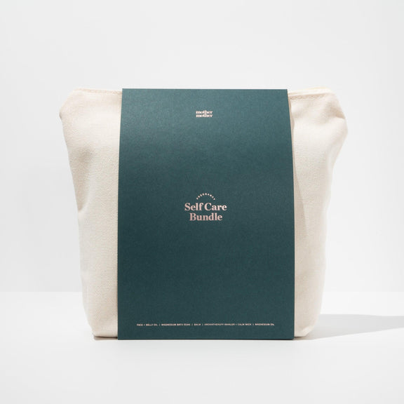 pregnancy and postpartum self care bundle in canvas bag on a white background