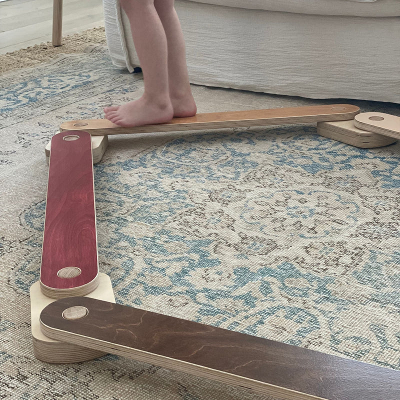 Child focused on balancing on a beam
