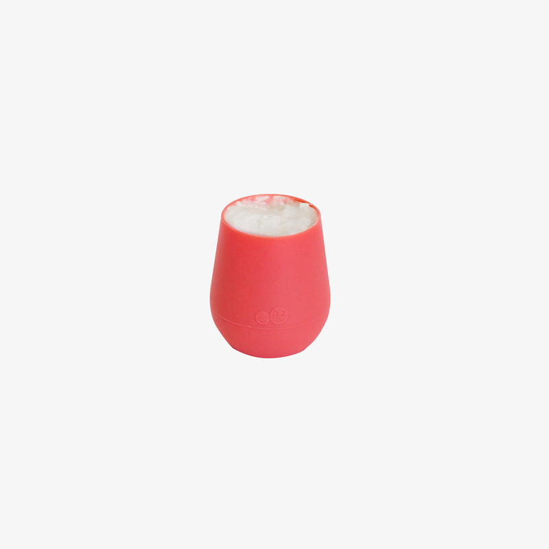 The Tiny Cup in Coral by ezpz / Open-Top, Silicone Drinking Cup for Babies #color_coral