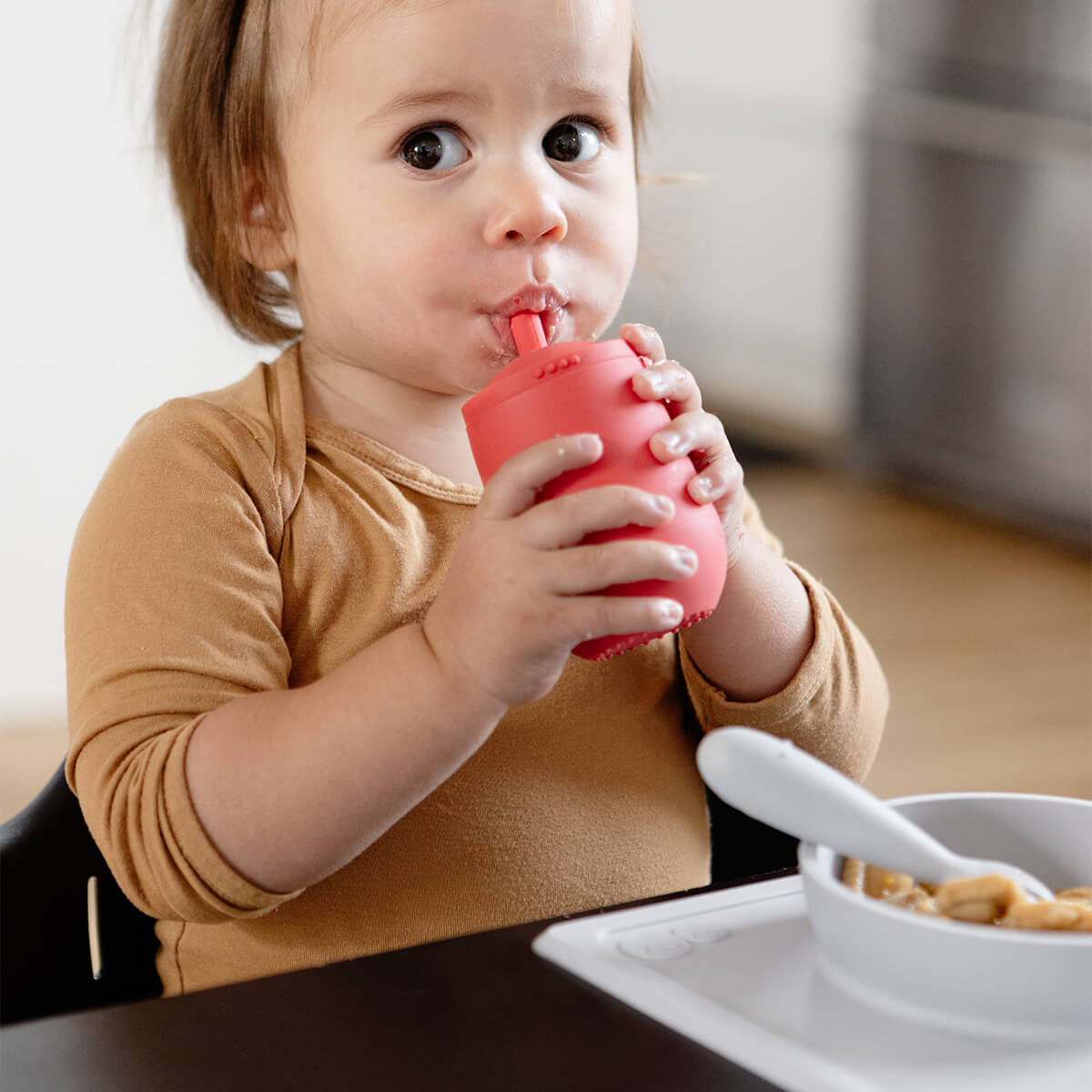 The Mini Cup + Straw in Coral by ezpz / Silicone Drinking Cup and Straw Training System for Toddlers #color_coral