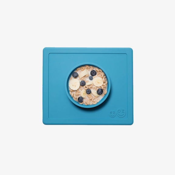 Happy Bowl in Blue by ezpz / The Original All-In-One Silicone Plates & Placemats that Stick to the Table #color_blue / Happy Bowl – Self-Feeding Made Simple for Babies & Toddlers by ezpz