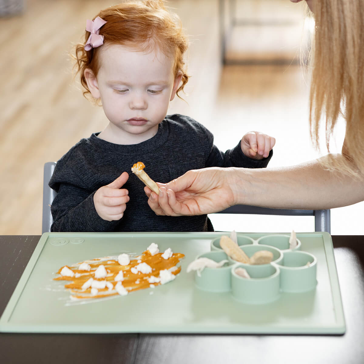 The Play Mat in Sage by ezpz / Large Silicone Craft Plate that Suctions to the Table #color_sage/ Play Mat – Non-Tip Craft + Activity Surface for Toddlers by ezpz