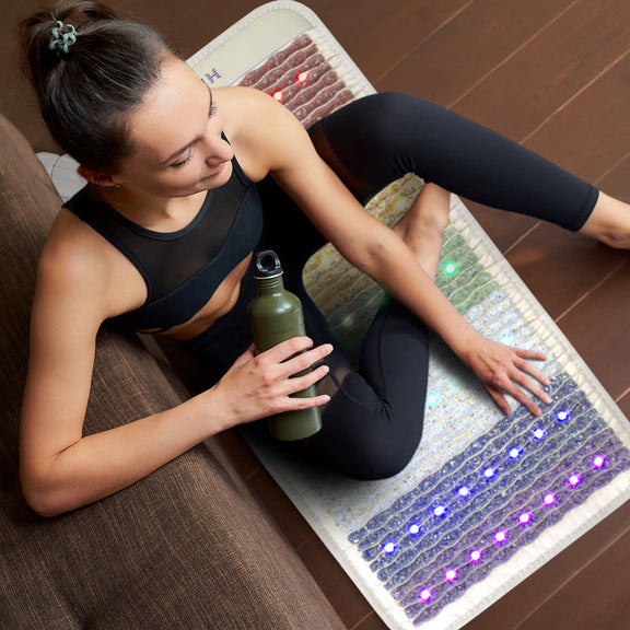PEMF grounding mat with chakra-aligning gemstones for relaxation