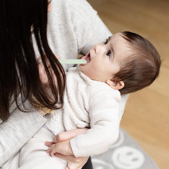 ezpz baby led toothbrush and sensory tongue depressor in sage green #color_sage