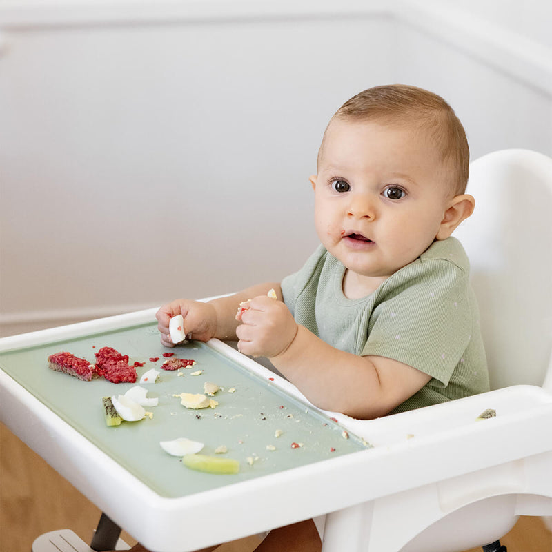 The Tiny Placemat in Sage is a non-slip, silicone placemat that fits on most highchair trays #color_sage / Tiny Placemat – On-the-Go Mealtime Mat for Babies & Toddlers