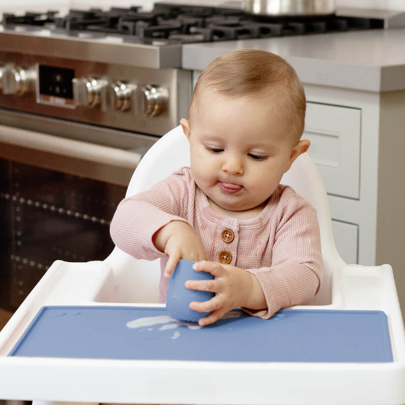 The Tiny Placemat in Indigo is a non-slip, silicone placemat that fits on most highchair trays #color_indigo / Tiny Placemat – On-the-Go Mealtime Mat for Babies & Toddlers