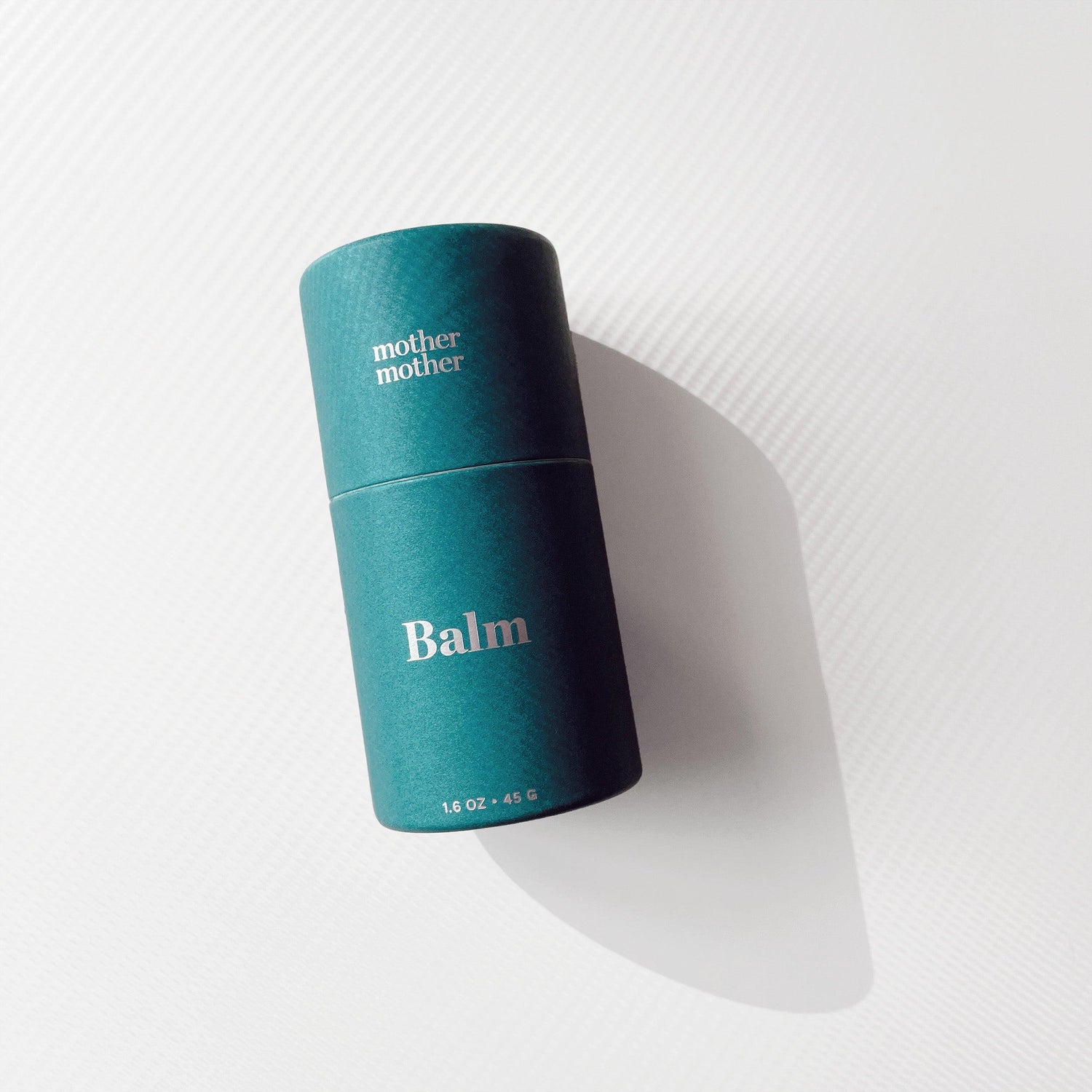 belly balm for pregnancy on a beige background