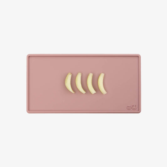 The Tiny Placemat in Blush is a non-slip, silicone placemat that fits on most highchair trays #color_blush