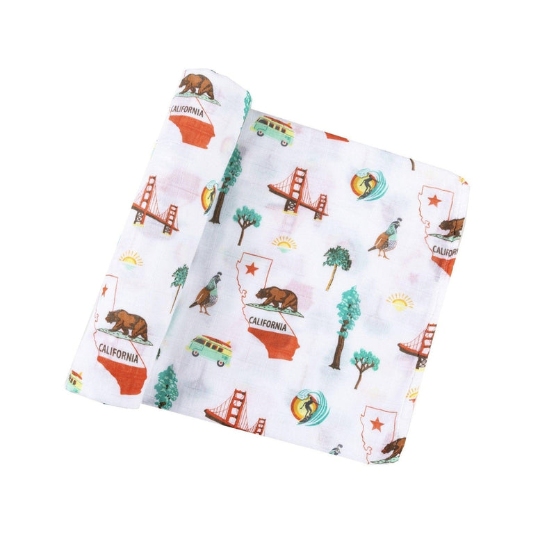 California Baby muslin swaddle blanket and burp cloth/bib combo set with playful bear and tree patterns.