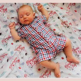Gift set with Georgia Boy muslin swaddle blanket and burp cloth/bib combo, featuring state-themed designs.