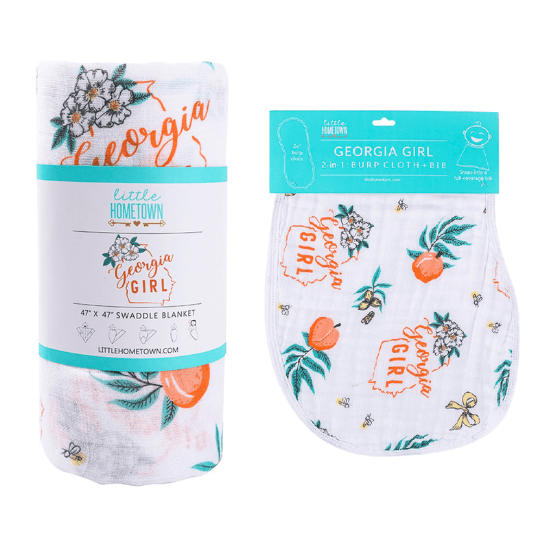 Gift set with "Georgia Girl" muslin swaddle blanket and burp cloth/bib combo, featuring peach and floral designs.