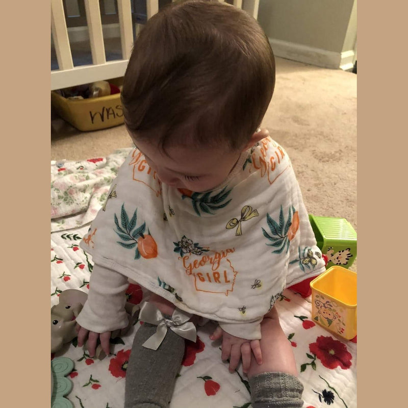 Georgia-themed muslin swaddle blanket and burp cloth set featuring peaches and state outline, neatly folded.