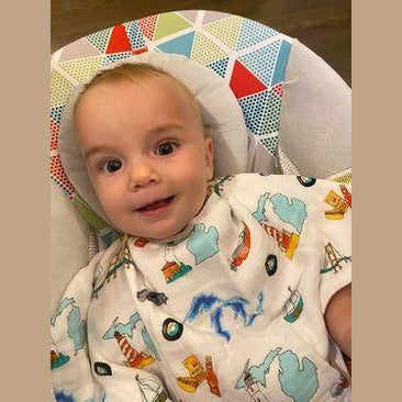 Michigan-themed baby gift set with muslin swaddle blanket and burp cloth/bib combo, featuring state icons.