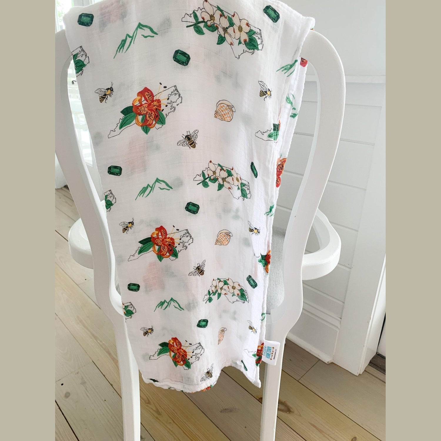 North Carolina-themed baby gift set with floral muslin swaddle blanket and matching burp cloth/bib combo.