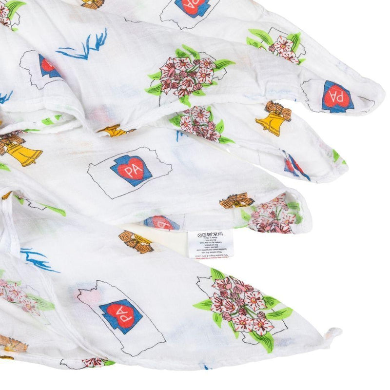 Pennsylvania-themed baby gift set with muslin swaddle blanket and burp cloth, featuring state icons and landmarks.