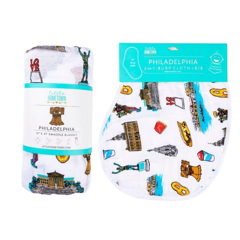 Philadelphia-themed baby gift set with muslin swaddle blanket and burp cloth, featuring iconic city landmarks.