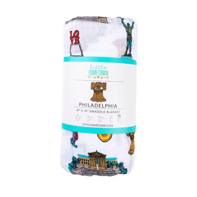 Philadelphia-themed baby gift set with muslin swaddle blanket and burp cloth, featuring iconic city landmarks.