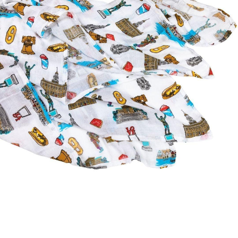 Philadelphia-themed baby gift set with muslin swaddle blanket and burp cloth, featuring iconic city landmarks.