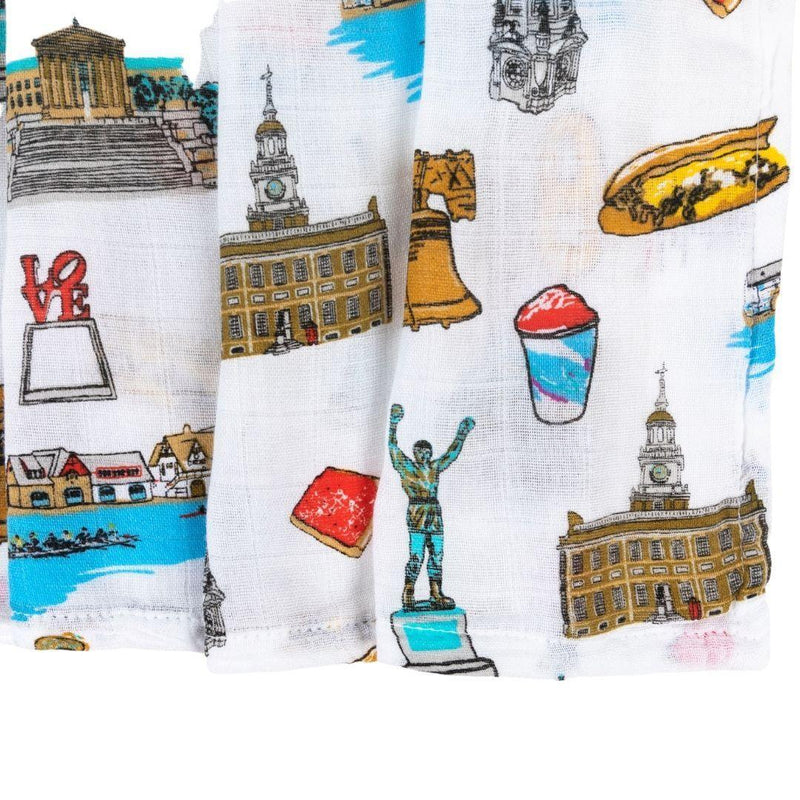 Philadelphia-themed baby gift set with muslin swaddle blanket and burp cloth, featuring iconic city landmarks.