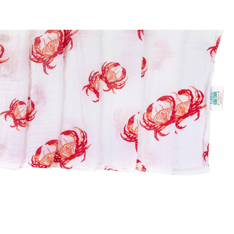 Pink crab-themed baby muslin swaddle blanket and burp cloth set, neatly folded on a white background.