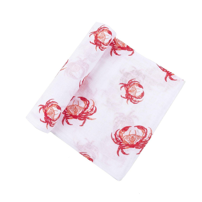 Pink crab-themed baby muslin swaddle blanket and burp cloth set, neatly folded on a white background.