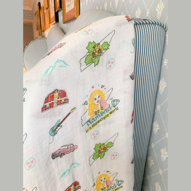 Floral-themed muslin swaddle blanket and burp cloth set with "Tennessee Baby" text, neatly folded on a white background.