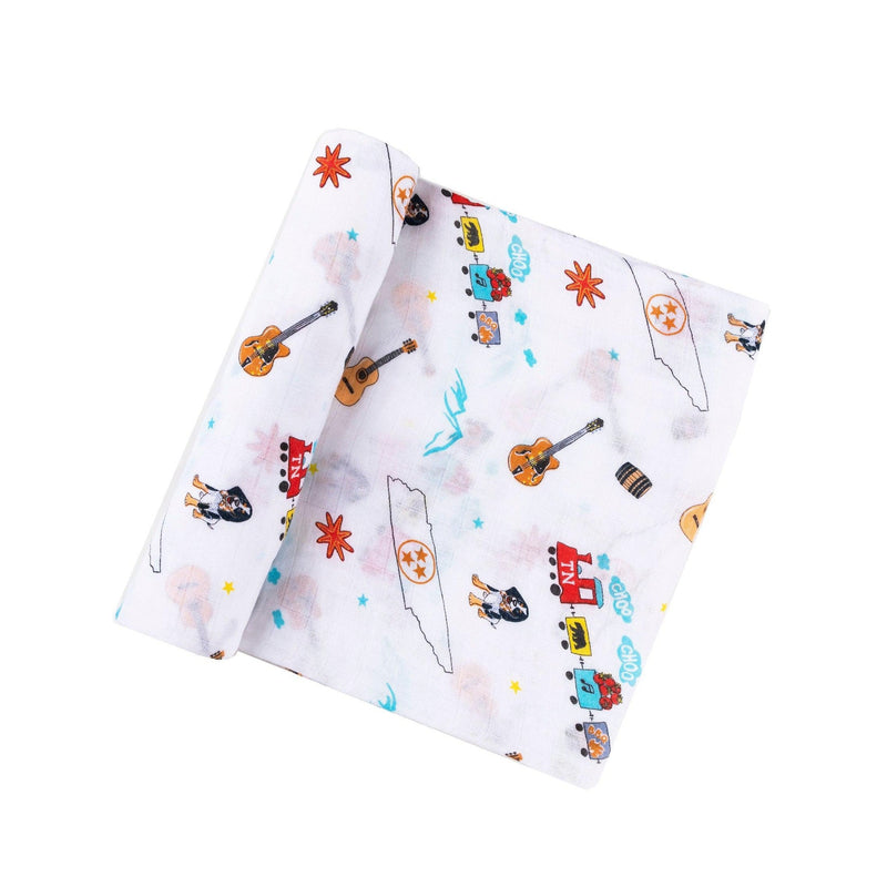 Tennessee-themed baby gift set with muslin swaddle blanket, burp cloth, and bib featuring state icons and landmarks.